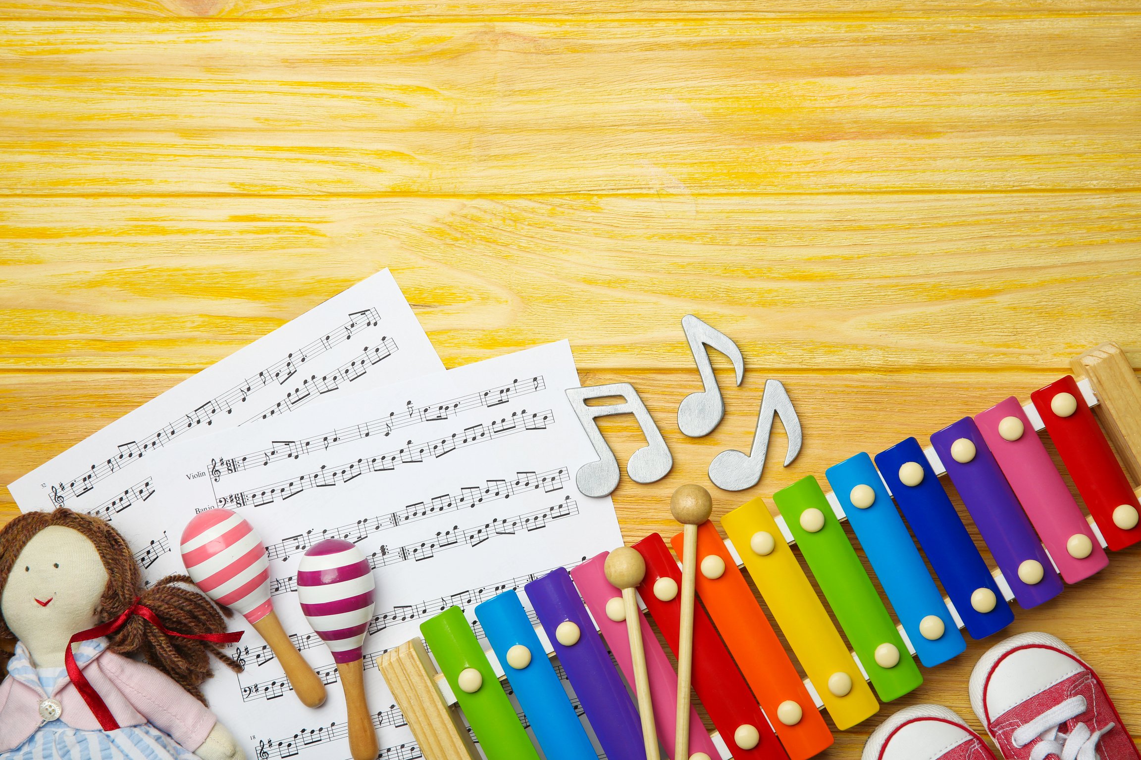 Beautiful Composition with Music Sheets on Wooden Background