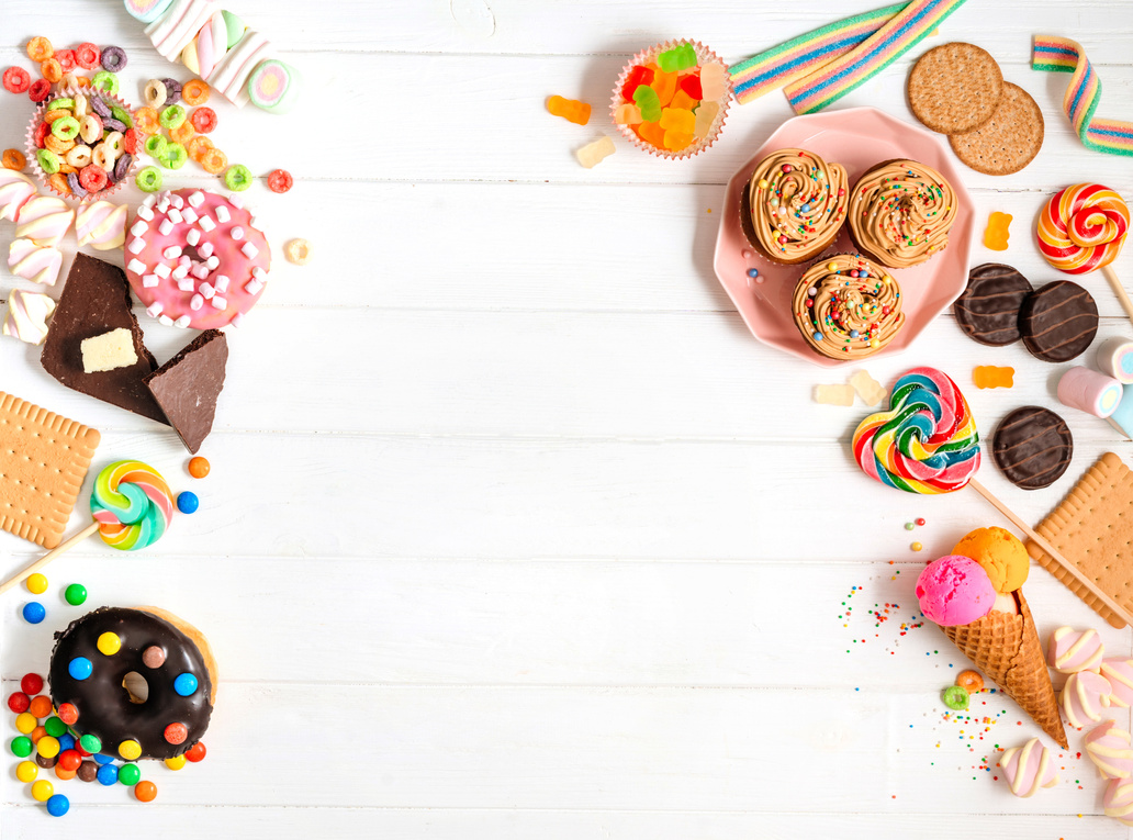 White wooden kids party background with sweet food